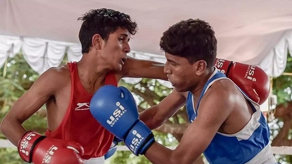 Nishan Manohar Kadam (in Red), who had been eyeing the boxing event when a massive flood in his village submerged and damaged the roads in his village. (image via Prasanna Kumar Iyengar/Facebook)