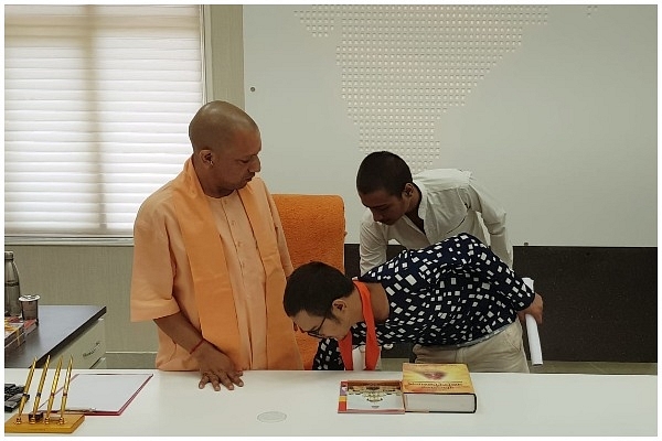 Kamlesh Tiwari’s son touches Chief Minister Yogi Adityanath’s feet.&nbsp;