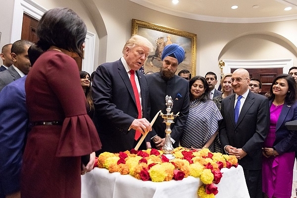 Trump lighting lamp at White House (Image via Donald Trump’s Twitter account)