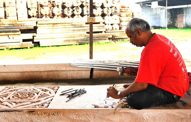 Worker cutting stone in workshop for preparation to build Ram temple (Burhaan Kinu/Hindustan Times via Getty Images)