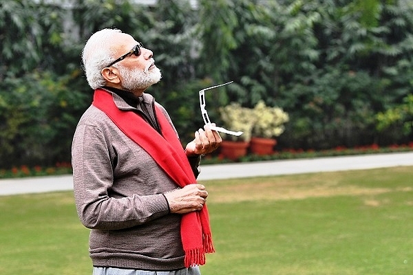 Prime Minister Narendra Modi trying to catch a glimpse of solar eclipse (@narendramodi/Twitter)