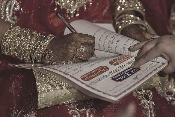 A woman signs a Nikah Nama -Representative Image (Photo by Kunal Patil/Hindustan Times via Getty Images)&nbsp;