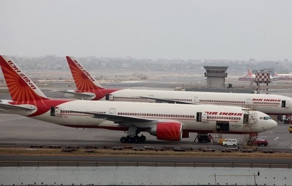 Air India aircraft are seen parked on the tarmac of the international airport in Mumbai. (Sattish Bate/Hindustan Times via Getty Images)