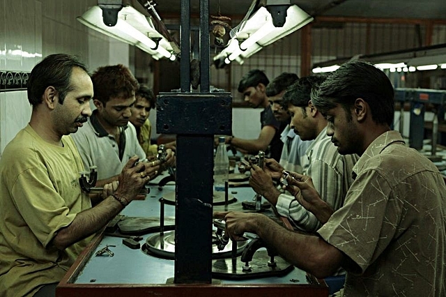 Workers at a factory near Mumbai. (Satish Bate/Hindustan Times via GettyImages)