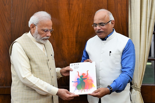 ICCR president Dr Sahasrabuddhe presenting a copy of the report to Prime Minister Modi.