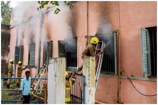 Firefighters attempt to douse fire after the clash between inmates.&nbsp;