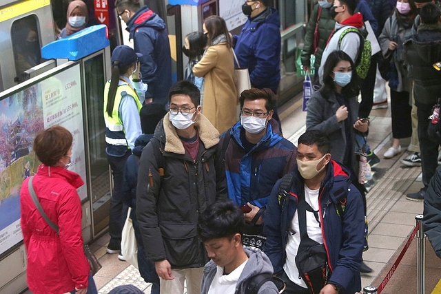 People with masks at a metro.