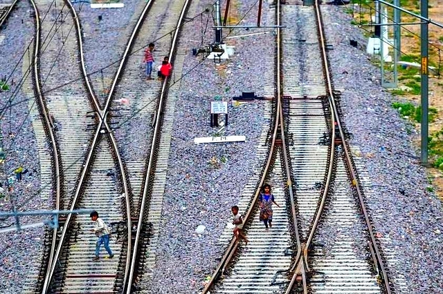 Children playing on rail tracks.&nbsp;