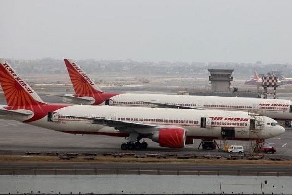 Air India aircraft are seen parked on the tarmac of the international airport in Mumbai. (Sattish Bate/Hindustan Times via Getty Images)