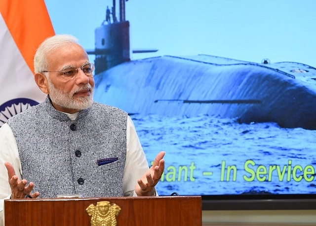 Prime Minister Narendra Modi speaking at an event with an image of INS Arihant, its clearest pictures, in the background. (@narendramodi/Twitter)