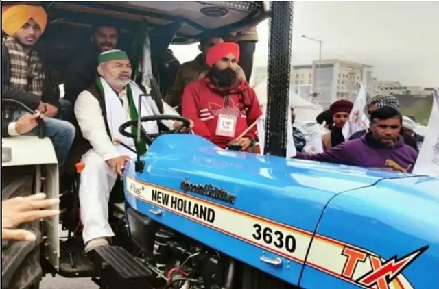 Bharatiya Kisan Union leader Rakesh Tikait driving a tractor in protests (Source: Twitter)