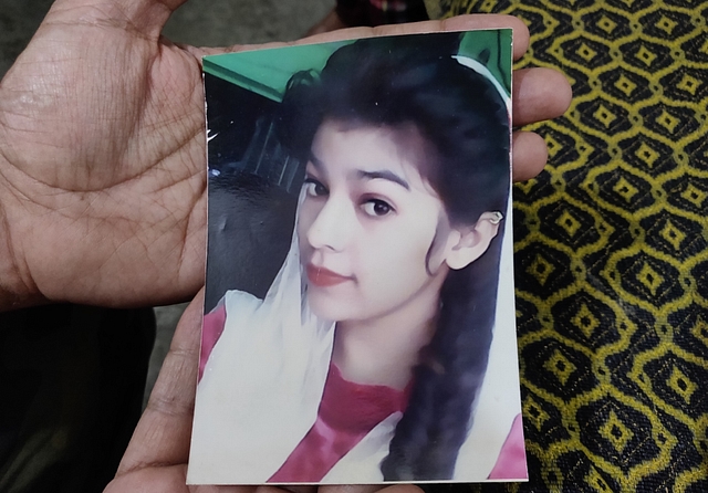 Baldev Singh holds a photograph  of his slain daughter Naina Kaur. (Picture clicked on 4 March 2021)