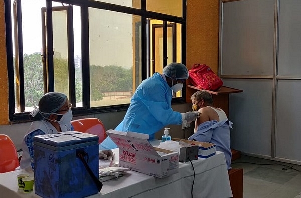 A railway employee being vaccinated in Delhi. 