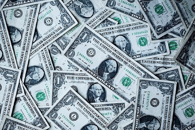 US Dollar bills. (Unsplash/Sharon McCutcheon)