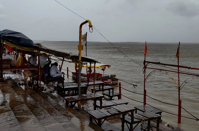Pandits wait by the bank of River Sarayu