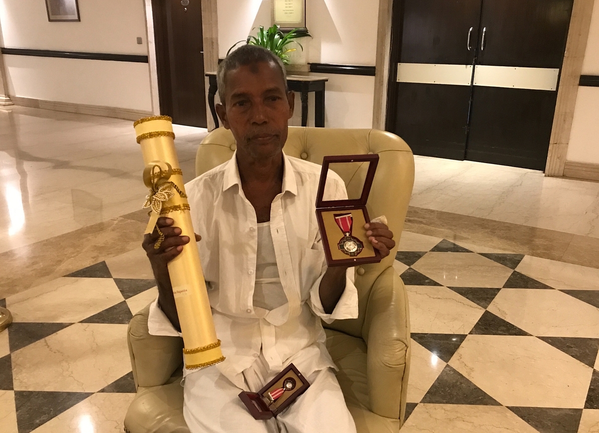 Harekala Hajabba with the Padma Shri award and the medals.
