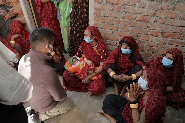 Minister Harsh Sanghavi with Kishan’s family holding Kishan’s 20-day-old daughter