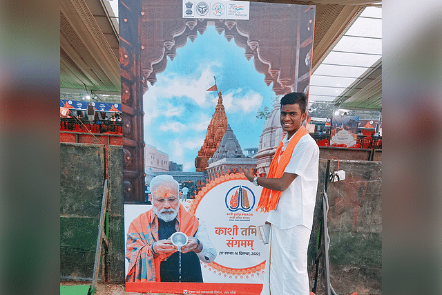 Prabathyan in front of Prime Minister Modi's image.