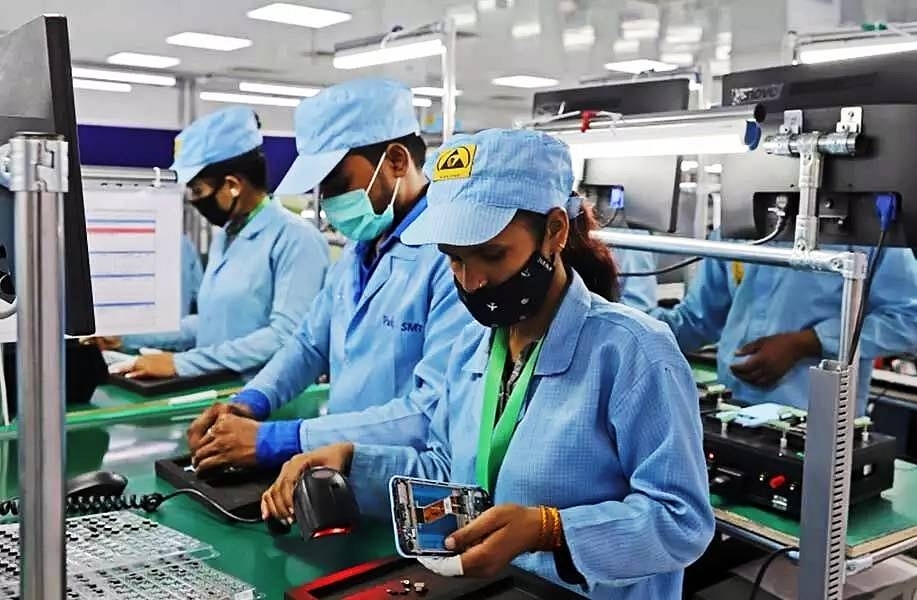 Phone manufacturing moves to India:  In a Dixon contract mobile phone plant. 