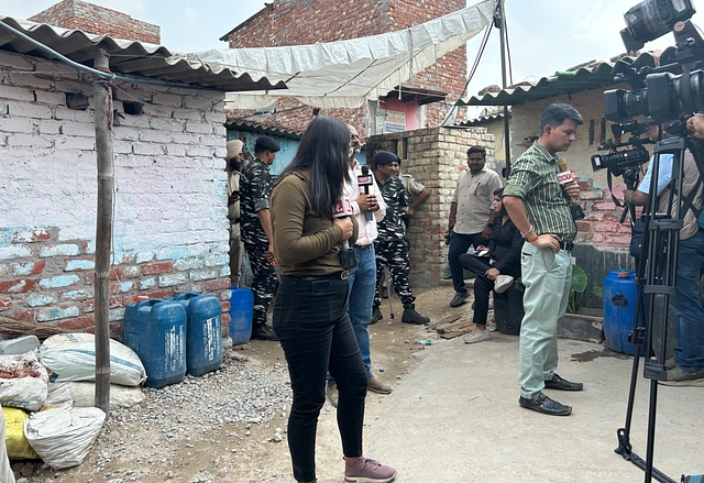 News channel reporters, policemen and paramilitary personnel outside the girl’s house