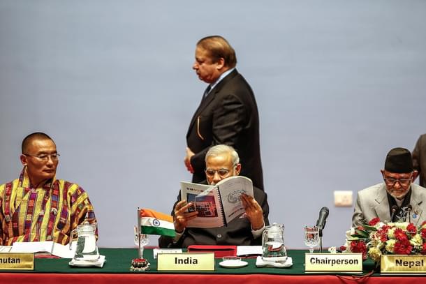 Pakistani Prime Minister Nawaz Sharf walks past Prime Minister Narendra Modi during an earlier SAARC meeting