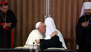 Pope Francis (L) and the head of the Russian Orthodox Church, Patriarch Kirill (R), kiss during a historic meeting in Havana on February 12, 2016. Pope Francis and Russian Orthodox Patriarch Kirill kissed each other and sat down together Friday at Havana airport for the first meeting between their two branches of the church in nearly a thousand years. AFP PHOTO / POOL - Alejandro Ernesto / AFP / POOL / ALEJANDRO ERNESTO (Photo credit should read ALEJANDRO ERNESTO/AFP/Getty Images)