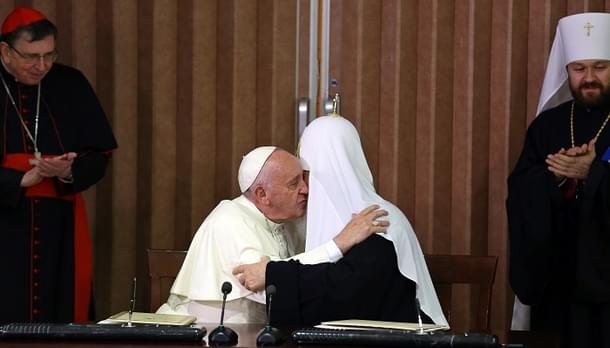 Pope Francis (L) and the head of the Russian Orthodox Church, Patriarch Kirill (R), kiss during a historic meeting in Havana on February 12, 2016. Pope Francis and Russian Orthodox Patriarch Kirill kissed each other and sat down together Friday at Havana airport for the first meeting between their two branches of the church in nearly a thousand years. AFP PHOTO / POOL - Alejandro Ernesto / AFP / POOL / ALEJANDRO ERNESTO (Photo credit should read ALEJANDRO ERNESTO/AFP/Getty Images)
