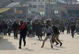 Kashmiri youth throwing stones at security forces. (GettyImages) 