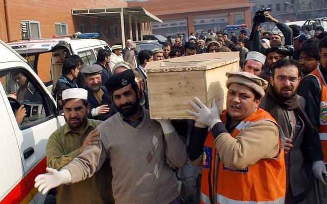 Pakistani volunteers move the coffin of a student from a hospital following an attack by Taliban in a Peshawar school.