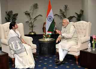 Prime Minister Modi in conversation with West Bengal Chief Minister Mamata Banerjee in Dhaka.