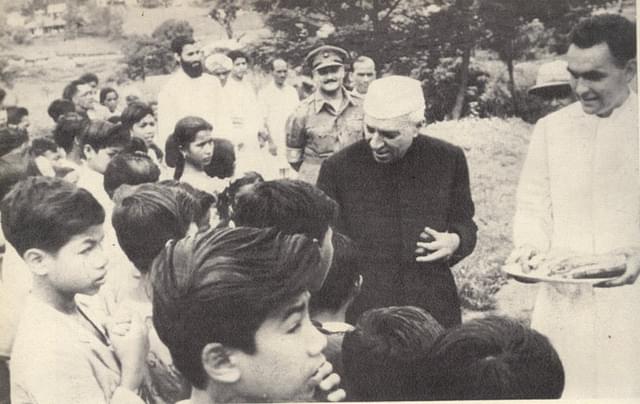 Nehru distributes sweets among children at <a href="https://en.wikipedia.org/wiki/Nongpoh">Nongpoh</a>, Meghalaya