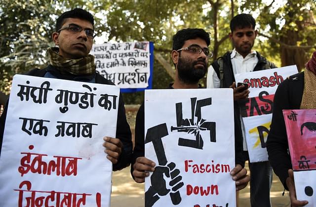 Indian activists of the DISHA Students Organistion hold placards against the February 15, 2016 attack on JNU students        (Photo credit should read PRAKASH SINGH/AFP/Getty Images)