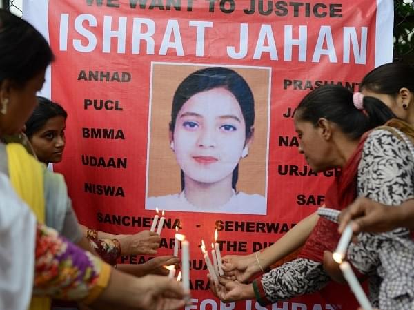 Candles in front of a banner bearing a portrait of Ishrat Jahan in Ahmedabad on July 6, 2013. (SAM PANTHAKY/AFP/Getty Images)
