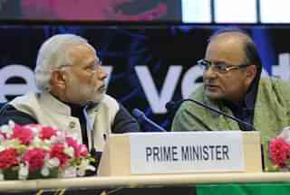 Indian Prime Minister Narendra Modi (L) and Finance Minister Arun Jaitley talk during an event to launch an initiative to bolster start-ups in New Delhi on January 16, 2016. Indian entrepreneurs will receive generous tax breaks and face dramatically reduced red tape when starting and closing a business, Prime Minister Narendra Modi said January 16, as he launched a pet initiative to bolster India's fast-growing startup scene. Speaking at a gathering of 2,000 entrepreneurs from India, Silicon Valley and elsewhere, Modi outlined a slew of measures under Start Up India including exempting startups from income tax for their first three years. AFP PHOTO / STR / AFP / STRDEL        (Photo credit should read STRDEL/AFP/Getty Images)