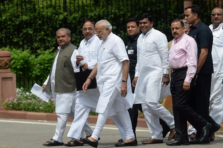Prime Minister Modi walks along with other officials