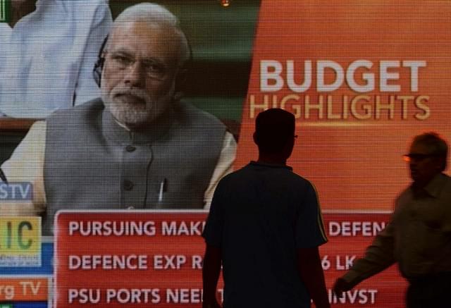 A digital screen showing PM Modi during the Budget speech. Credits: AFP PHOTO / PUNIT PARANJPE