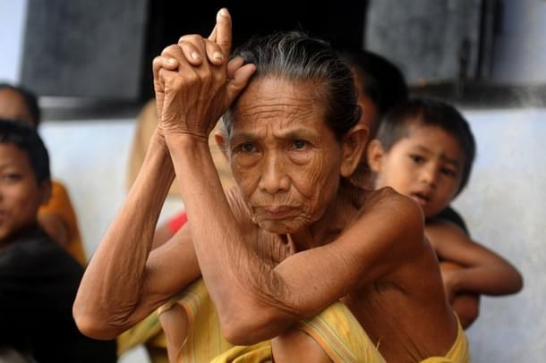 Indian displaced Bodo tribeswomen and children rest at a relief camp in Gosaigaon village in Assam state’s Kokrajhar district on July 29, 2012