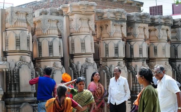 Devotees gather beside stone pillars earmarked for the Ram temple.