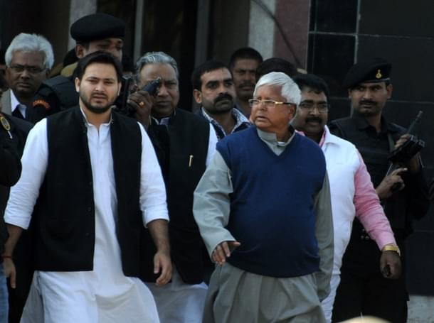 Tejaswi Yadav (L) with his father Lalu Yadav (R)(Credits: AFP PHOTO/STR)