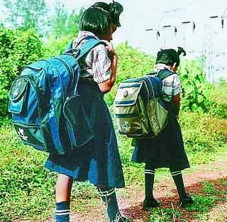 Children carrying heavy school bags