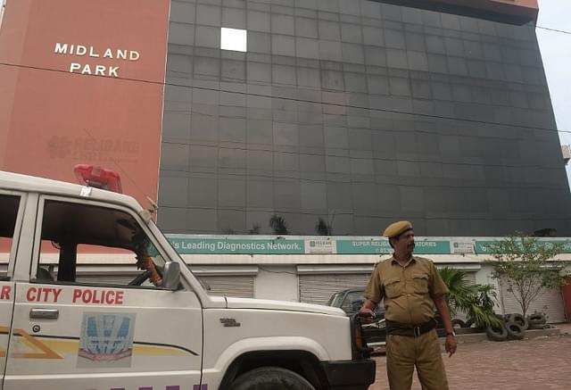 A policeman stands guard outside the closed head office of the Saradha group in Kolkata.