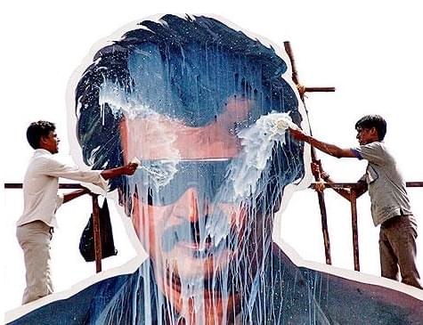 Fans pour milk on a Rajinikanth cut-out.
