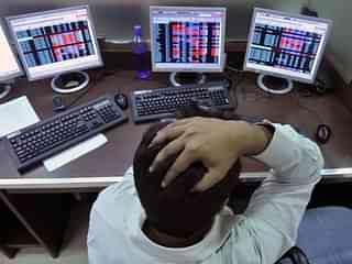  An Indian stockbroker reacts as he watches share prices.(Photo credit: INDRANIL MUKHERJEE/AFP/GettyImages)