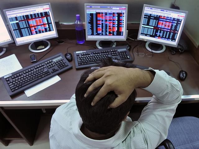 

An Indian stockbroker reacts as he watches share prices on his computer during intraday trade at a brokerage firm in Mumbai on August 3, 2011. Indian shares slid as much as 1.23 percent and below the 18,000-point level in early trade August 3, tracking regional markets on concerns of a weakening global outlook. The benchmark 30-share Sensex index on the Bombay Stock Exchange fell 223.32 points to a day’s low of 17,886.57, before recovering marginally to 17,943.47 but still down 0.92 percent. AFP PHOTO/Indranil MUKHERJEE (Photo credit: INDRANIL MUKHERJEE/AFP/GettyImages)