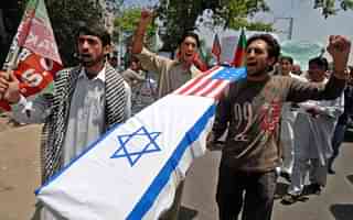 

Pakistani Shiite Muslim protesters carry a coffin wrapped in US and Israeli flags during a protest in Peshawar on May 16, 2008 to mark the 60th anniversary of the Jewish state. Al-Qaeda chief Osama bin Laden slammed Western leaders for taking part in Israel’s 60th birthday celebrations and vowed that Muslims would not give up ‘one inch of Palestine,’ in an audio message. AFP PHOTO/Tariq MAHMOOD (Photo credit: TARIQ MAHMOOD/AFP/Getty Images)