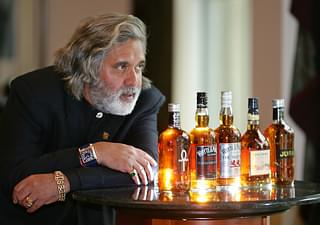Vijay Mallya posing for the cameras after United Spirits Limited, the flagship of his UB Group, had acquired a hundred percent of scotch whisky maker Whyte and Mackay for GBP595m in 2007.  (Photo credit: CARL DE SOUZA/AFP/Getty Images)