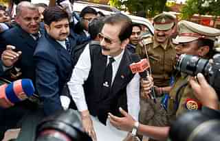 

Security officials escort India’s Sahara group chairman Subrata Roy (C) on his arrival at the Supreme Court in New Delhi on March 4, 2014. Roy was arrested after he failed to respond to the Supreme Court’s summons to appear in court in connection with the case in which Sahara owes millions of investors over 22,000 crore Indian rupees (3.5 billion dollars). AFP PHOTO/Prakash SINGH (Photo credit: PRAKASH SINGH/AFP/Getty Images)