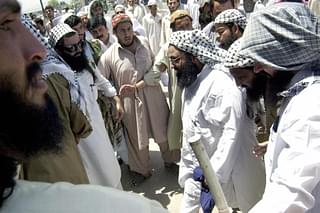 

Maulana Masood Azhar (3rd R), head of an outlawed militant organization of Jaish-e-Mohammad makes his way towards a mosque in Peshawar. Azhar’s terror outfit has been linked to the recent Pathankot attacks. (Photo credit: TARIQ MAHMOOD/AFP/Getty Images)