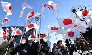 People Carrying Japanese Flag/Getty Images