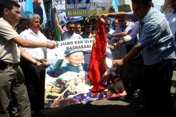 Uighurs living in Turkey set a Chinese flag on fire/Getty Images